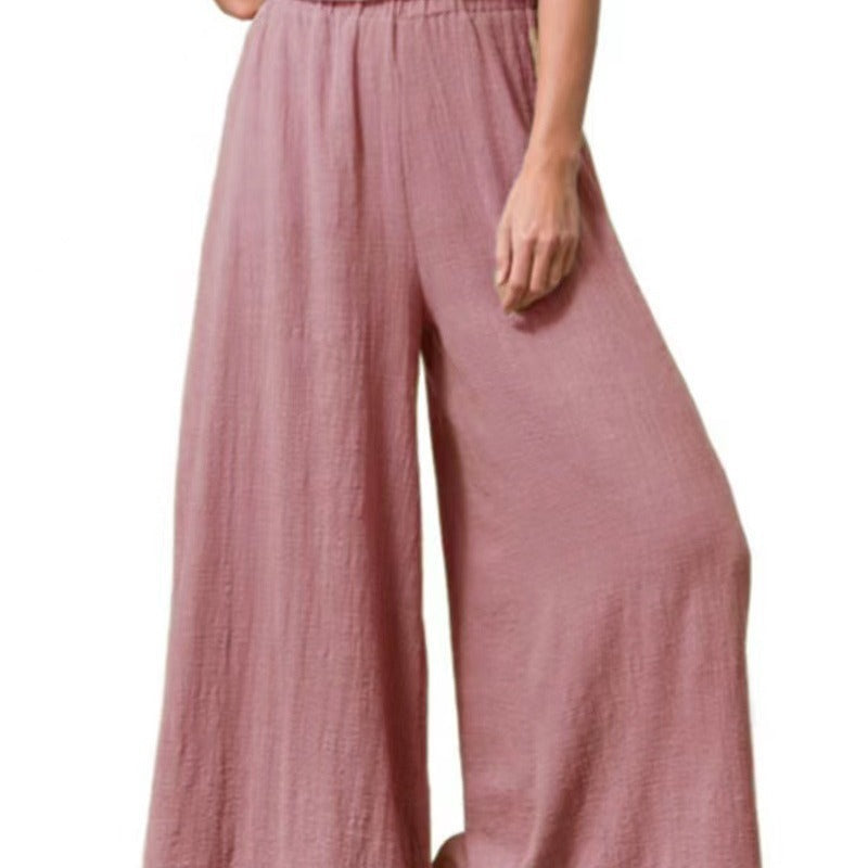 Femme portant un pantalon large oversize rose clair en coton et lin – coupe fluide et taille haute pour un confort estival signé Luxorel