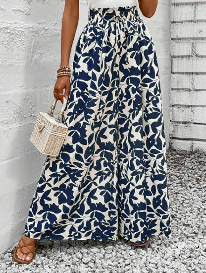 Femme portant un pantalon large à motifs floraux noir et blanc, coupe fluide et taille haute – style bohème chic signé Luxorel